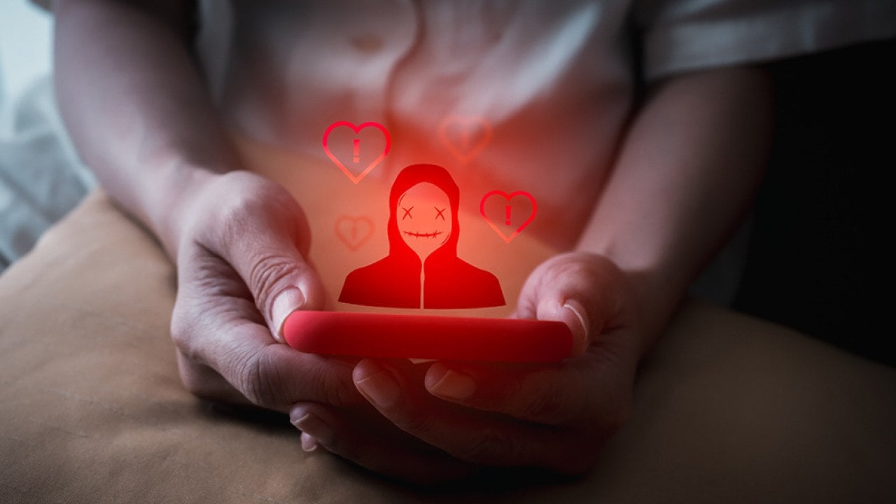 A person using a smartphone illustrated with a red anonymous identity graphics.