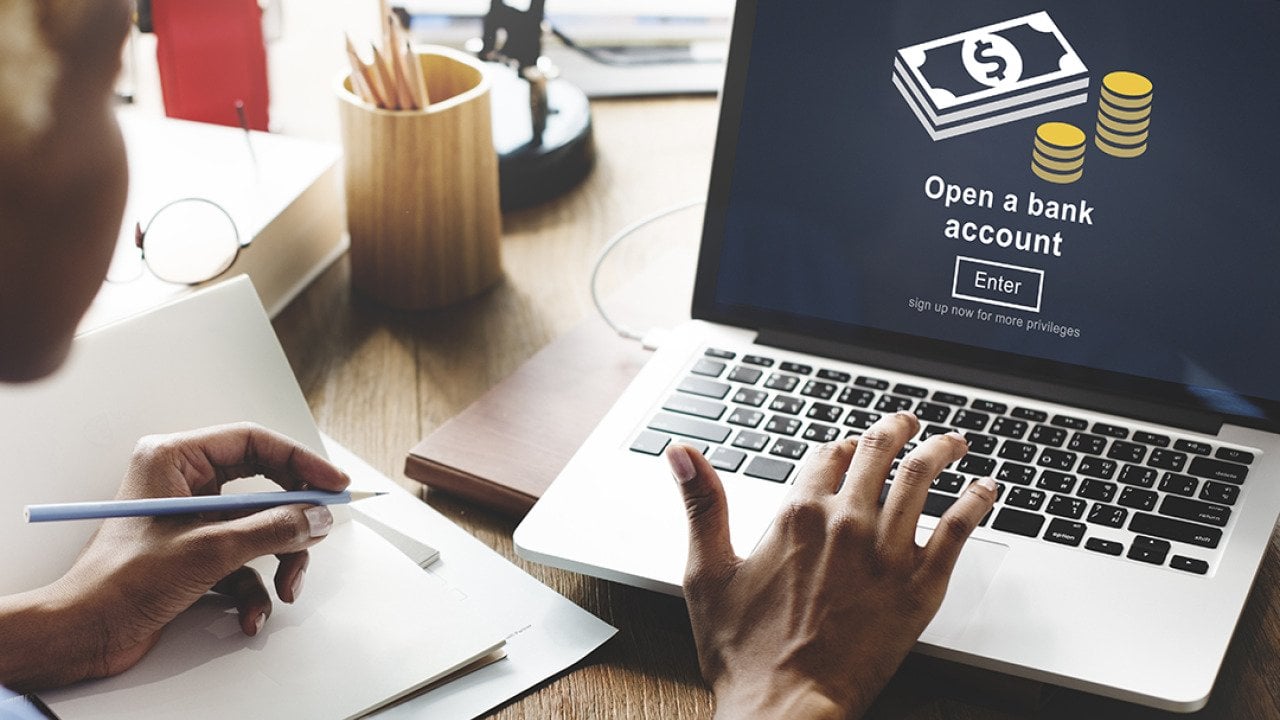 A businesswoman navigates a page to open a bank account.