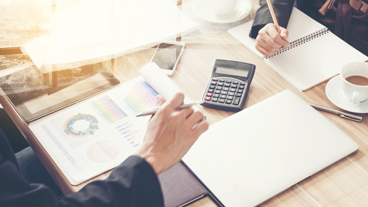 Business partners review financial documents.