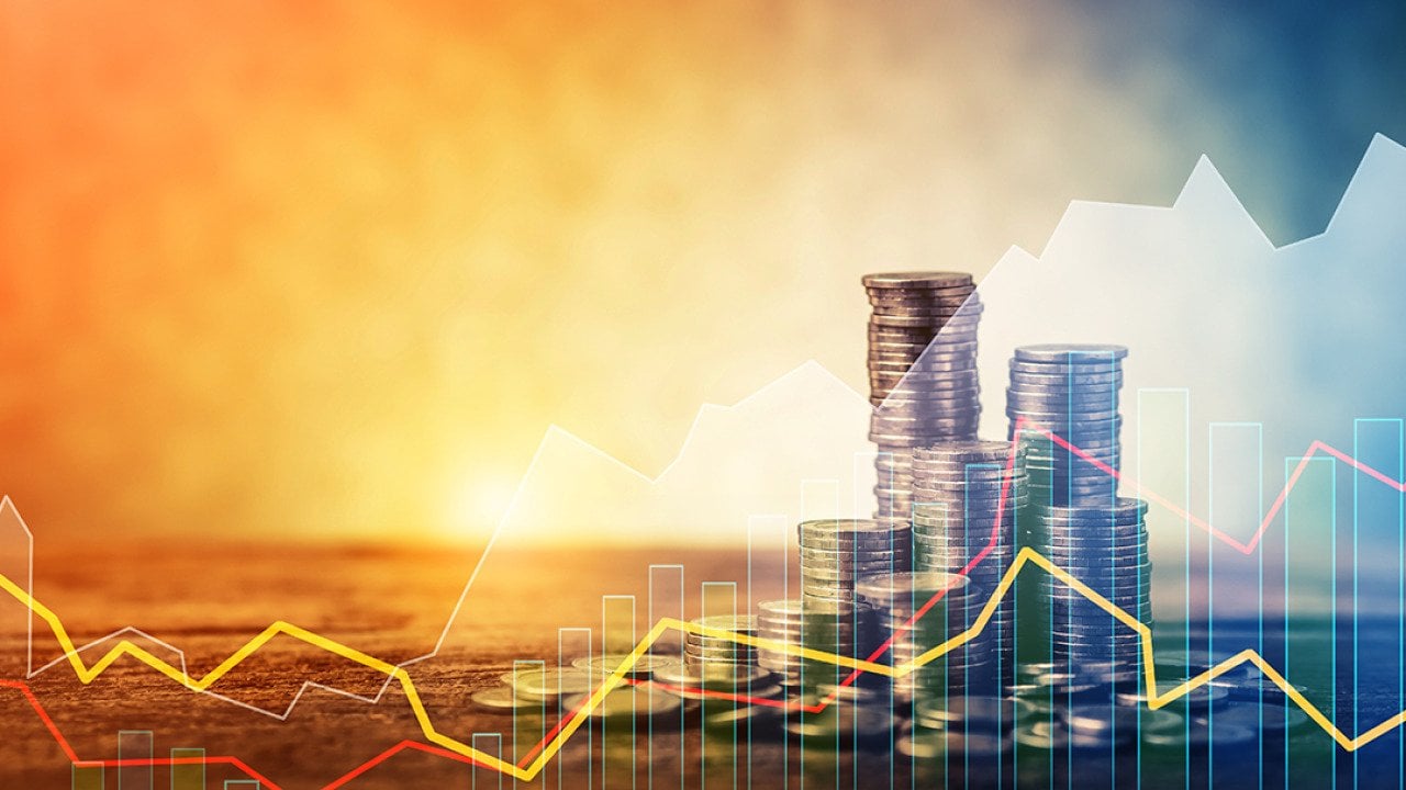 Stacks of coins with an overlay of steady stock trendline graphics.