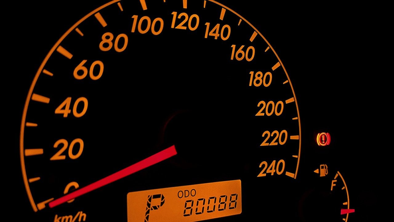 A car's orange-colored speed odometer displaying 80,088km.