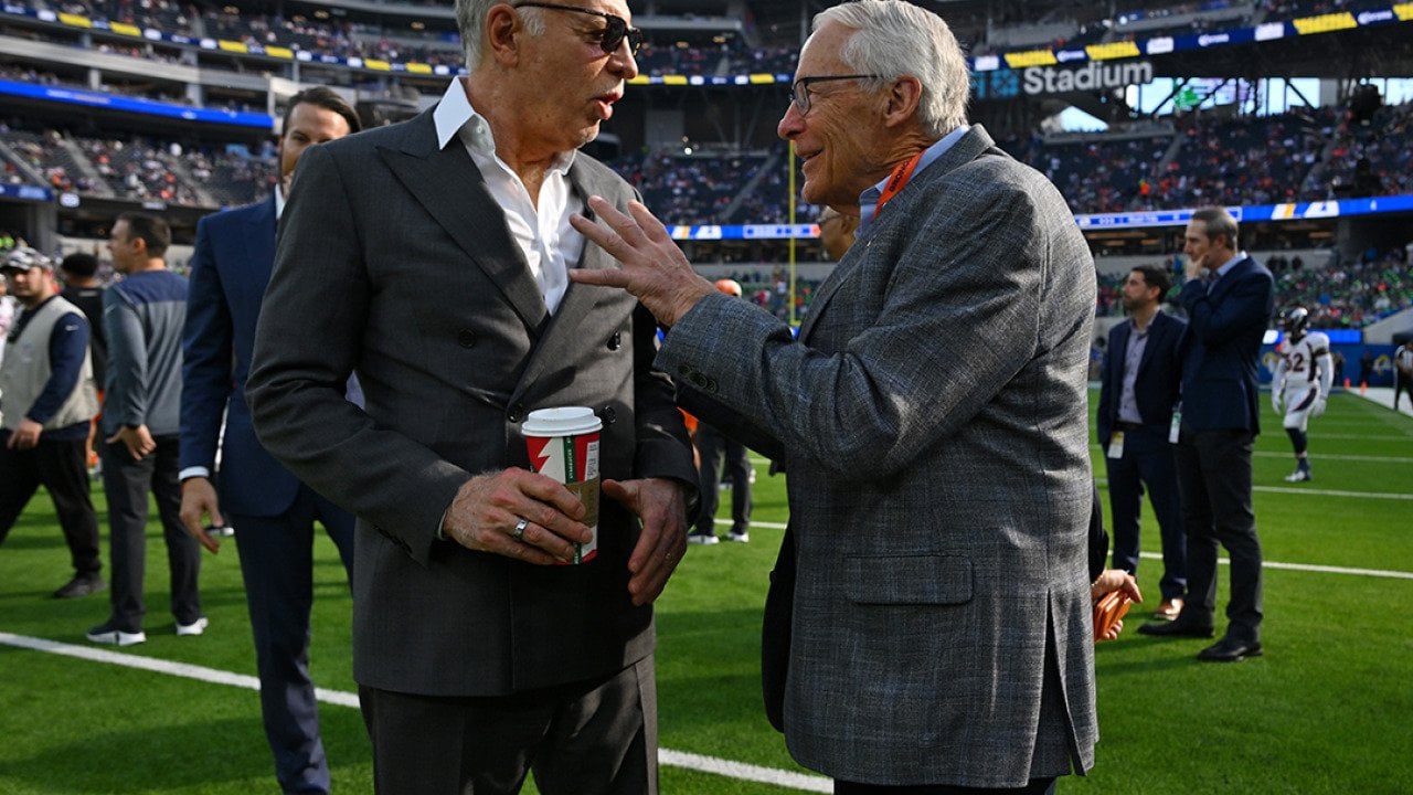 Stan Kroenke, owner of the Los Angeles Rams, talks with Rob Walton, owner of the Denver Broncos before a game at SoFi Stadium in Inglewood, California.