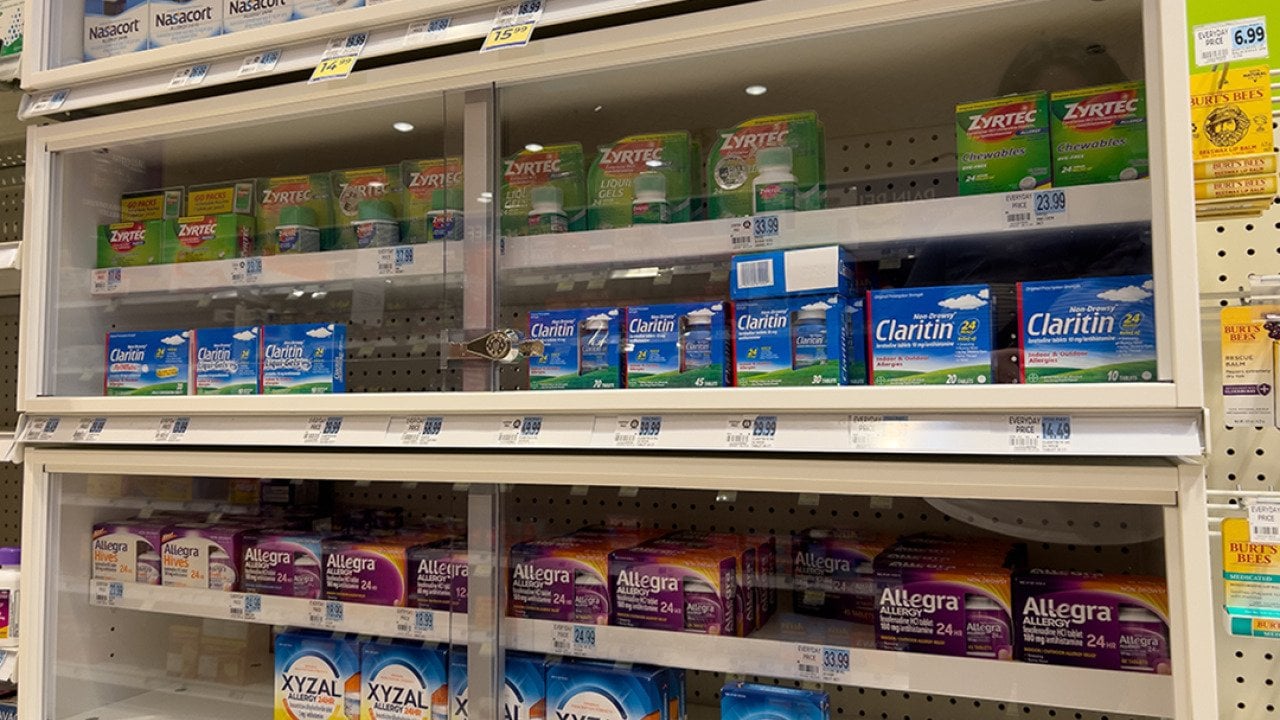 Xyzal and Zyrtec inside a pharmacy shelf with other allergy and sinus products.
