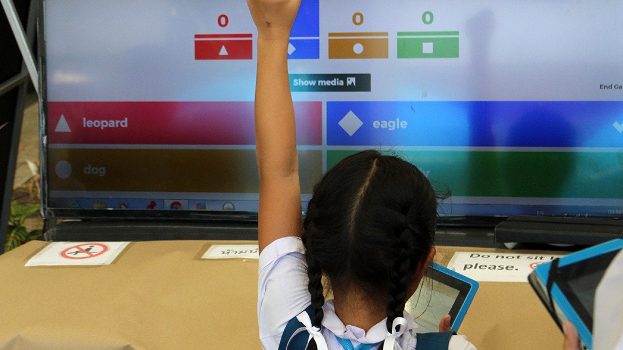 A young student celebrates a correct answer in an educational online game.