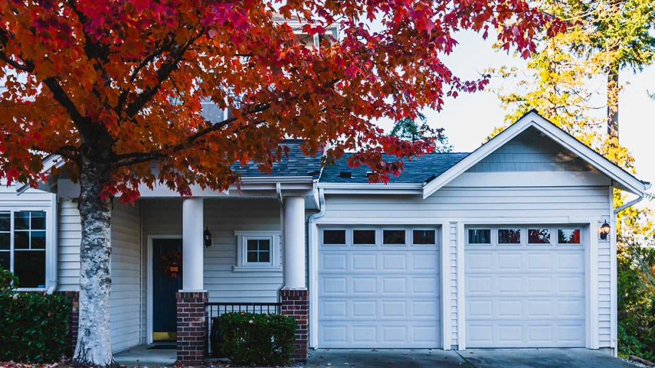 The front of a modern residential home during fall time.