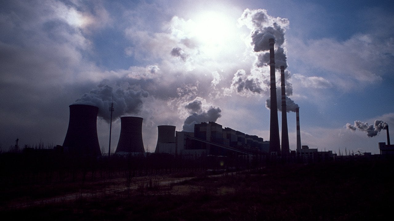 Silhouette of a coal-fired power plant spewing smoke into the air in Daqi, Inner Mongolia Autonomous Region, China.