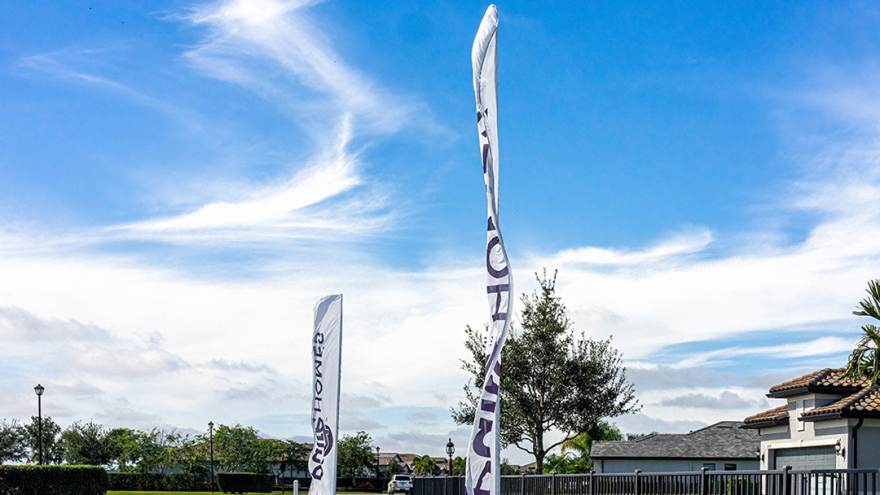 Sign banner flags outside a residential home community built by developer company, Pulte PulteGroup, in Florida.