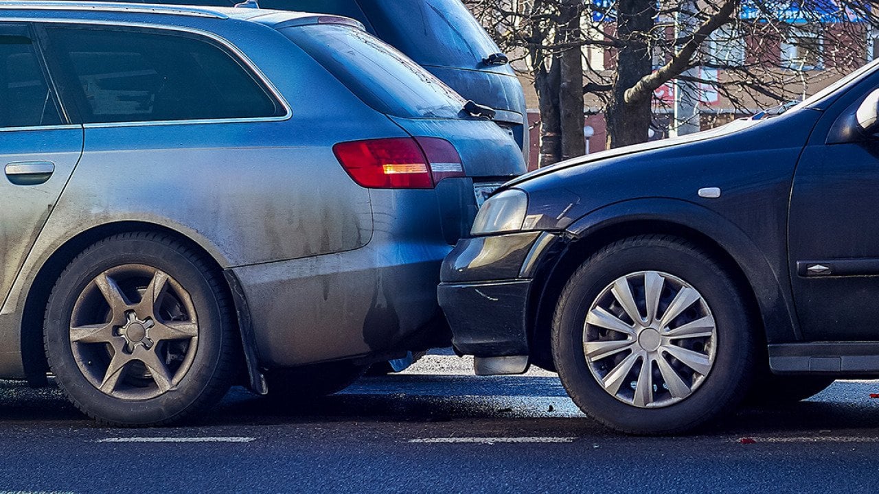 Two cars crashed on a street.