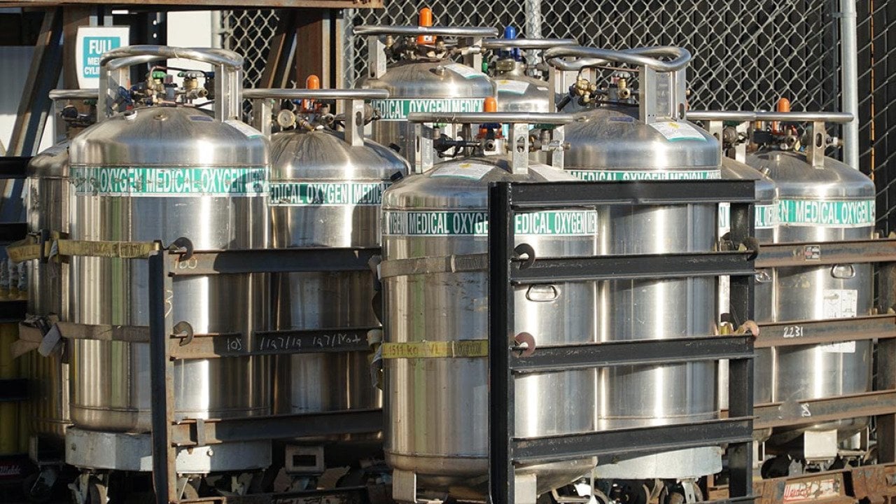 Industrial Oxygen cylinders waiting in racks outside filled and waiting to be put into use in Watsonville , California.