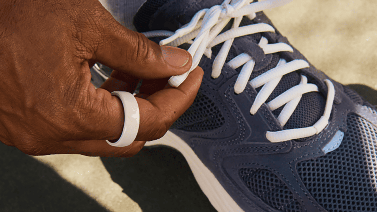 Close up on a navy athletic shoe's strings being tied up.