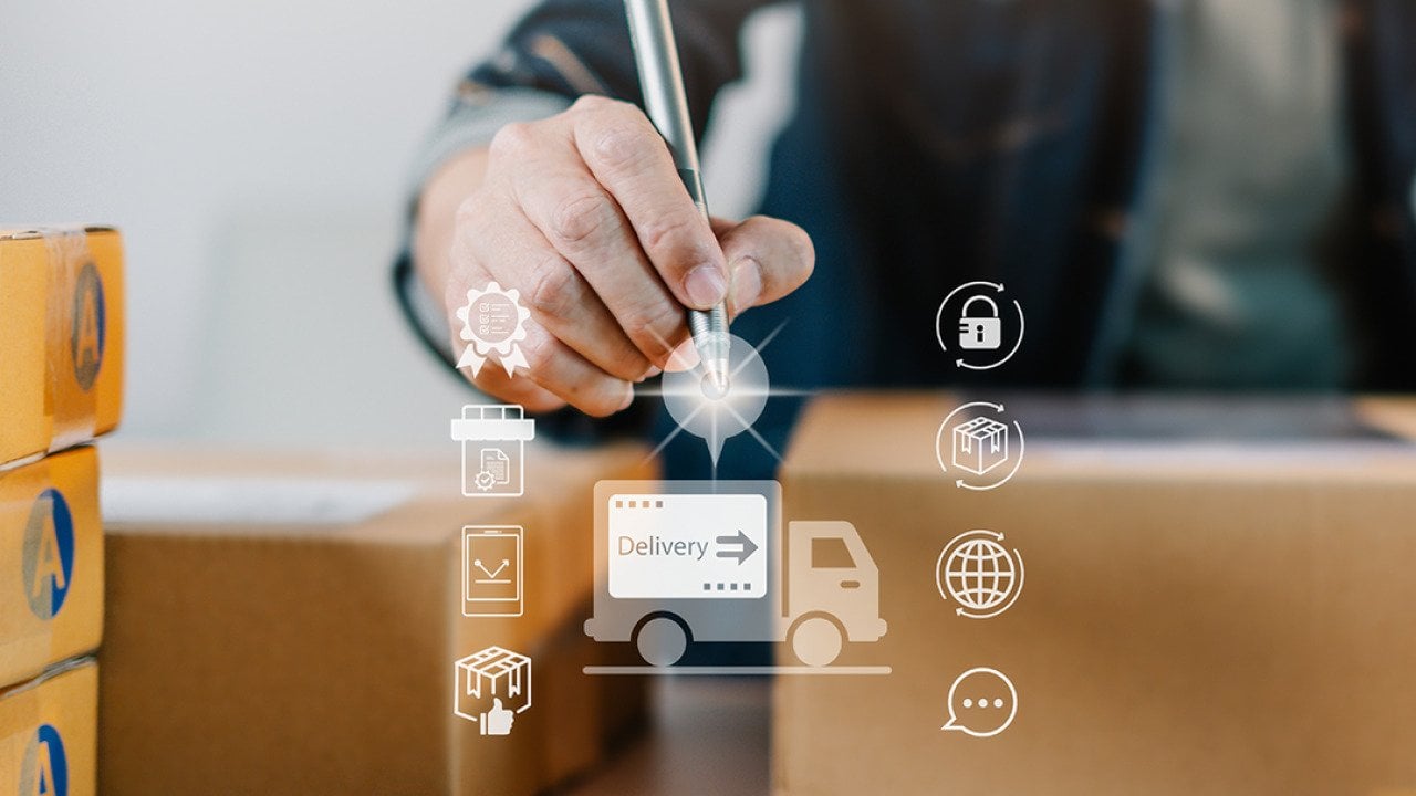 A logistics worker fulfills boxes of orders illustrated with a modern delivery system software graphics.