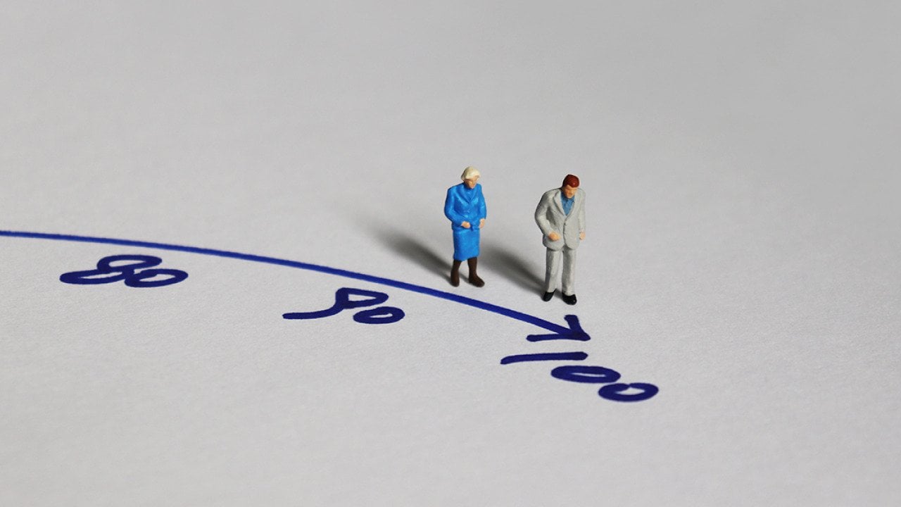 A miniature of an old couple walking towards the figure 100.