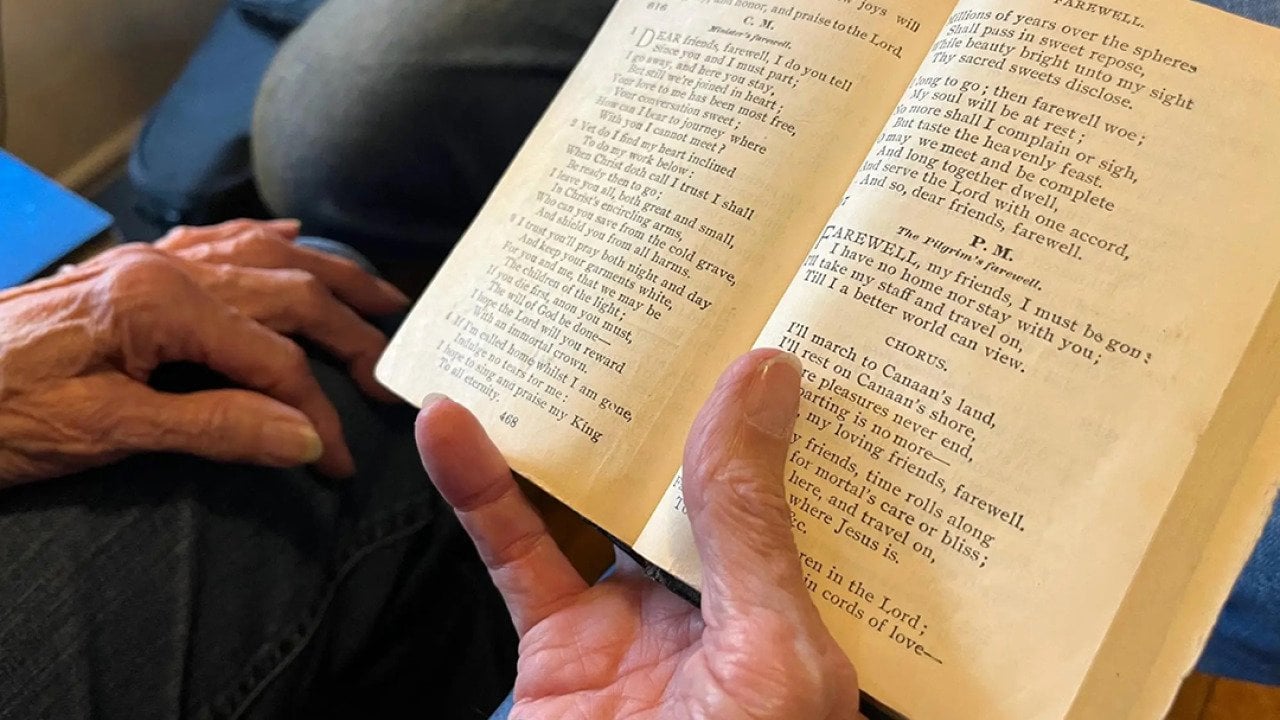 'Amazing Grace' as it appears in Ginny Hawker's family heirloom songbook, Lloyd’s Primitive Baptist Hymns. You can see stains in the margins, left by the tobacco-covered hands of her aunt Annie Maud Puckett. 
