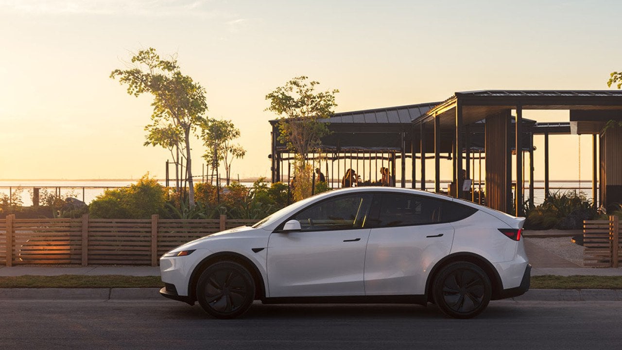 A white Tesla Model Y on the road.