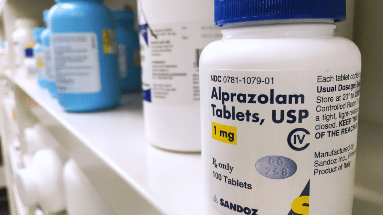 Xanax bottle on shelf.