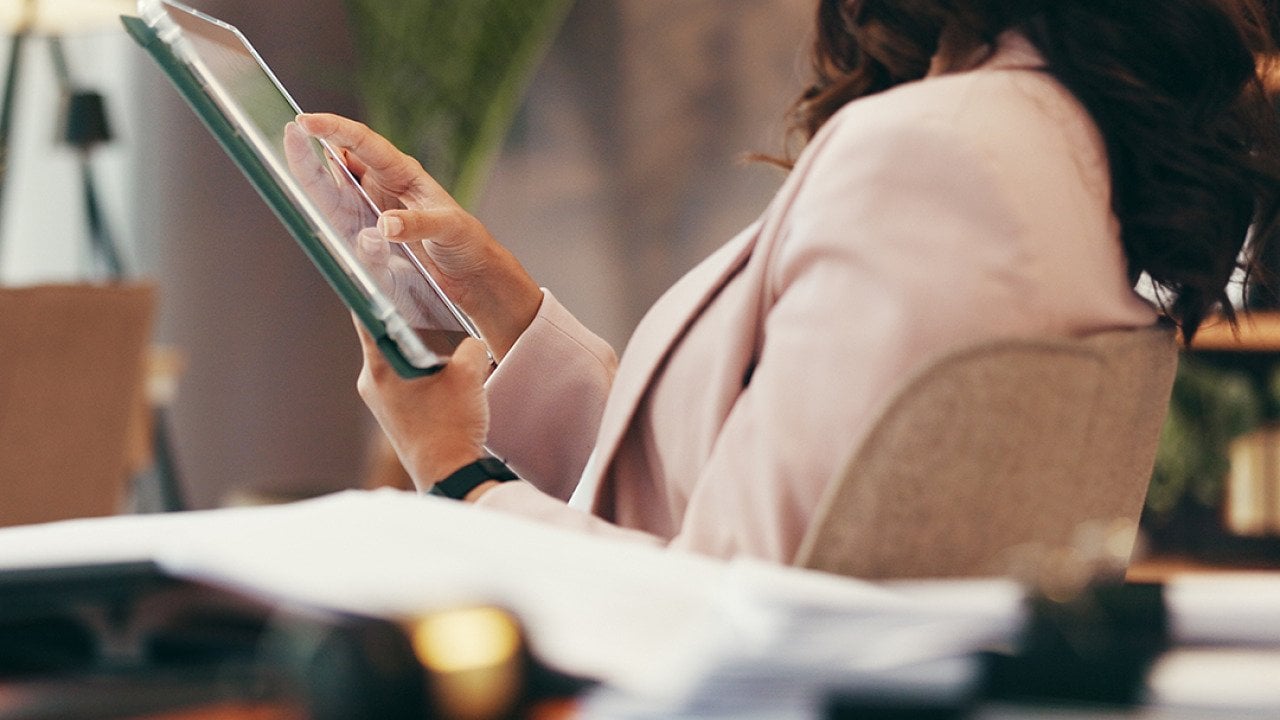 A female lawyer using a tablet in her home office.