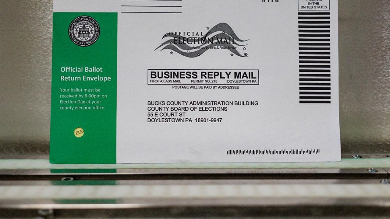 A Pennsylvania mail-in ballot with a green stripe on the envelope is displayed during a processing demonstration at the Board of Elections office on September 30, 2024 in Doylestown, Pennsylvania.