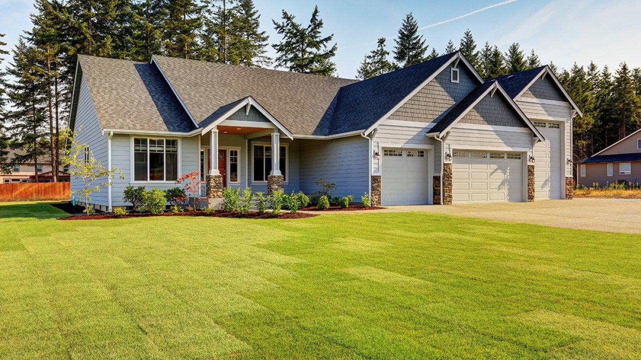 A modern, luxury home with a wide lawn in a Northwestern residential neighborhood in the US.