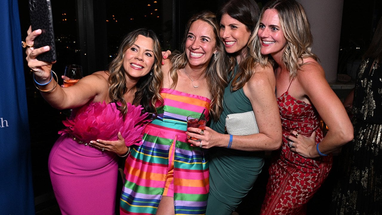 Marisa Peters (2nd L) poses for a selfie with guests at the BE SEEN Gala on June 7, 2025 at Harriet's Rooftop in Los Angeles, California.