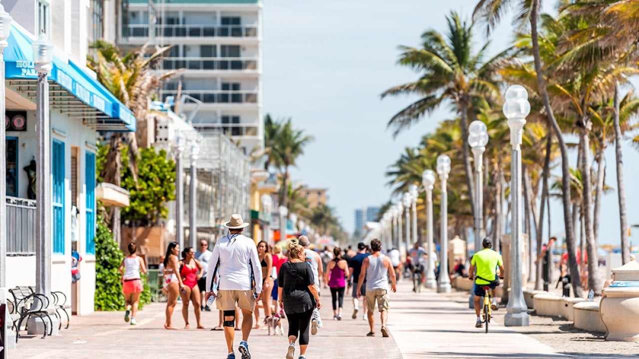 People along the beach boardwalk in Miami, Florida.
