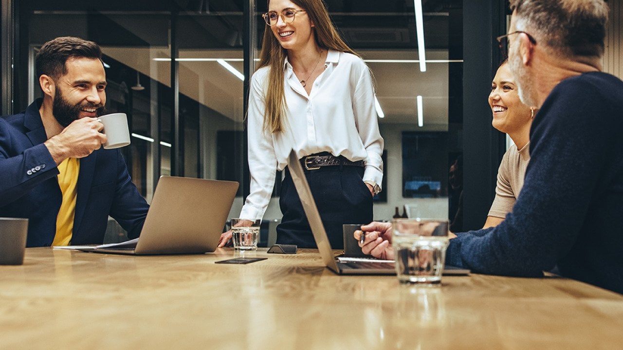 A happy business team having a meeting in a boardroom.