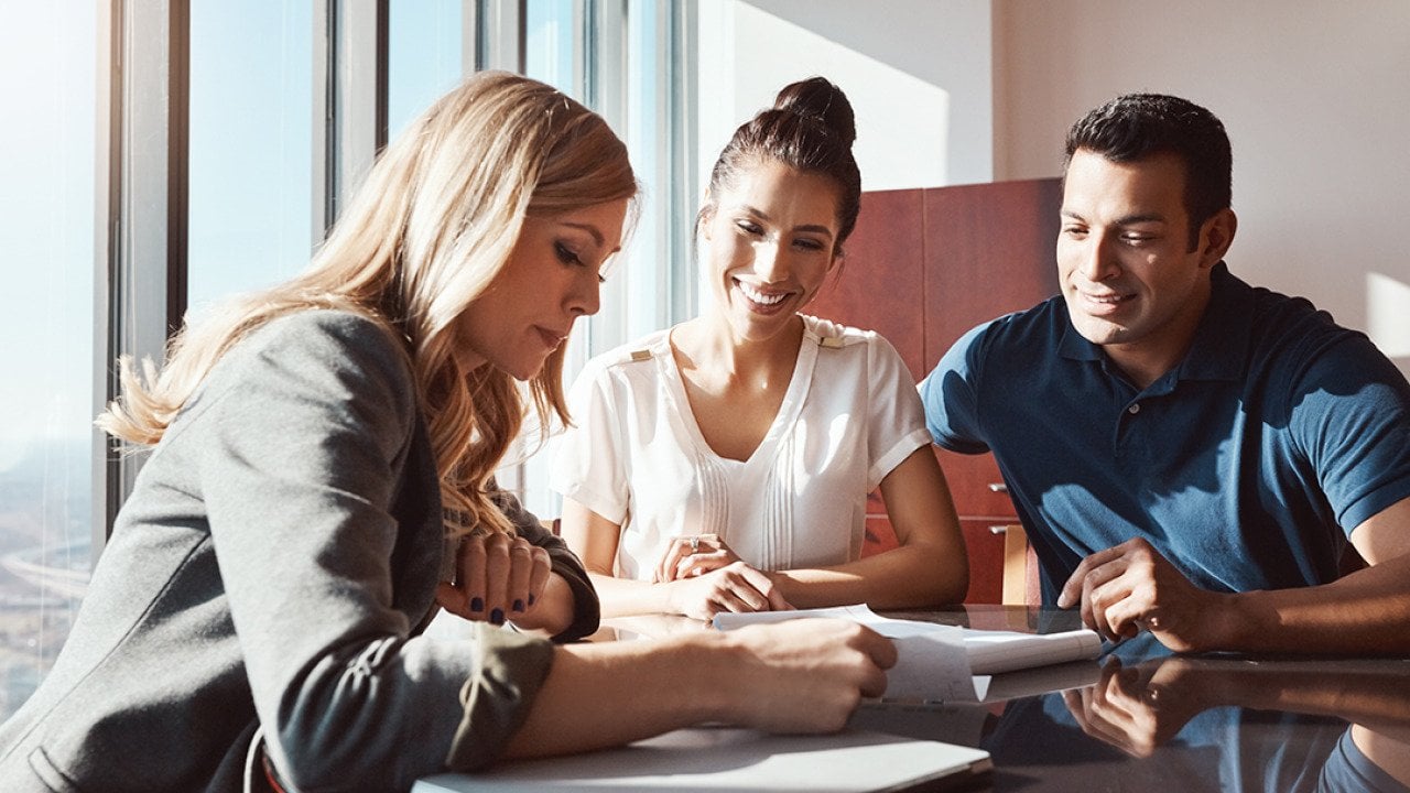 A couple engaging in a discussion with a financial advisor.
