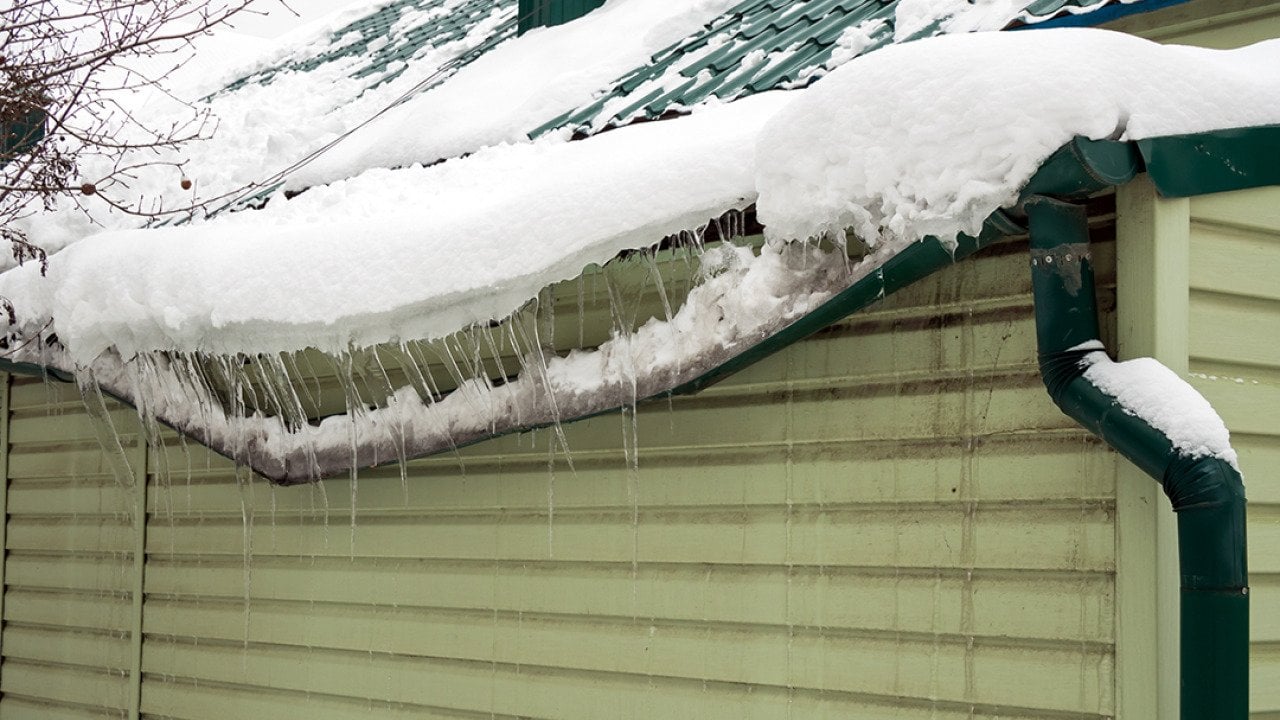Heavy snow destroys as it accumulated on a home's drainage system.