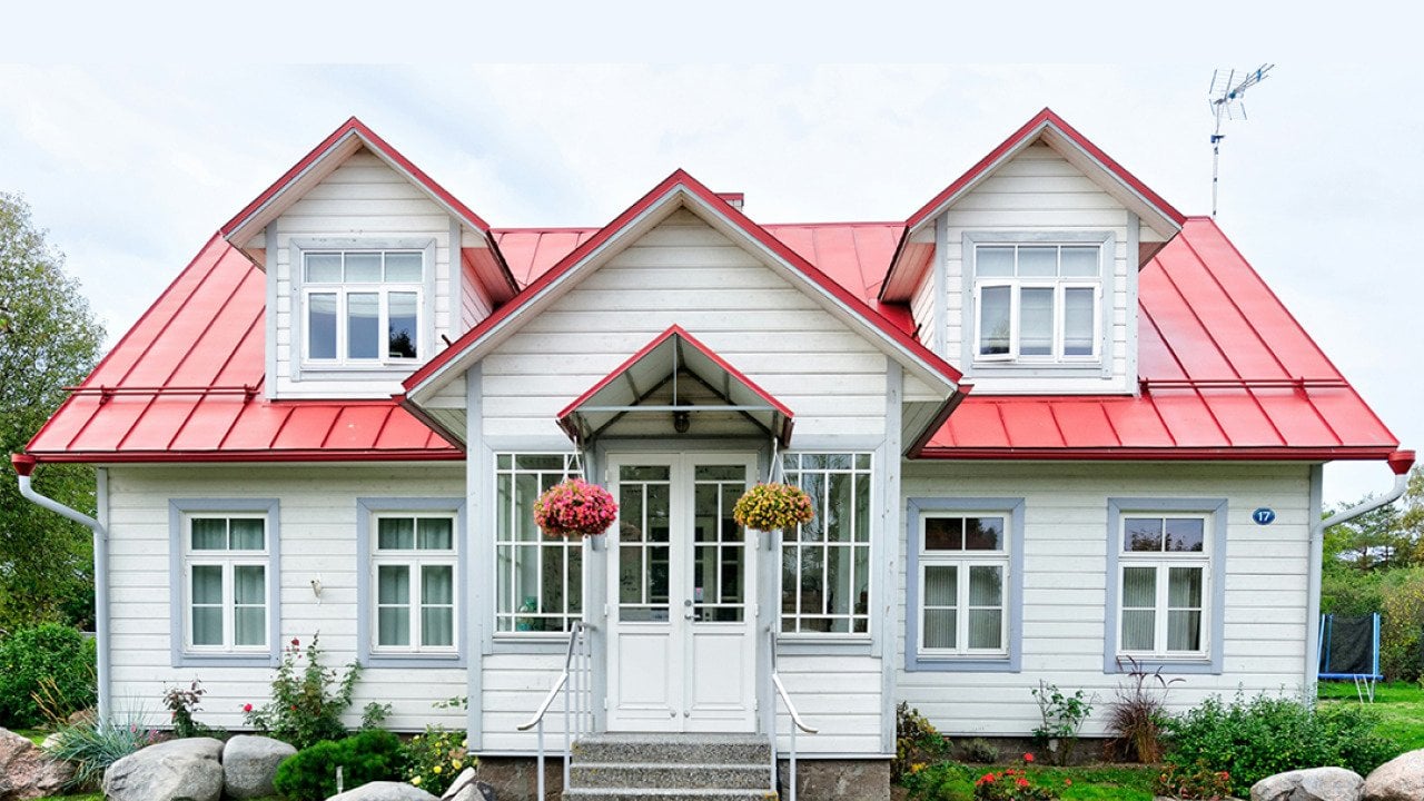 A large residential home with white and red exterior.
