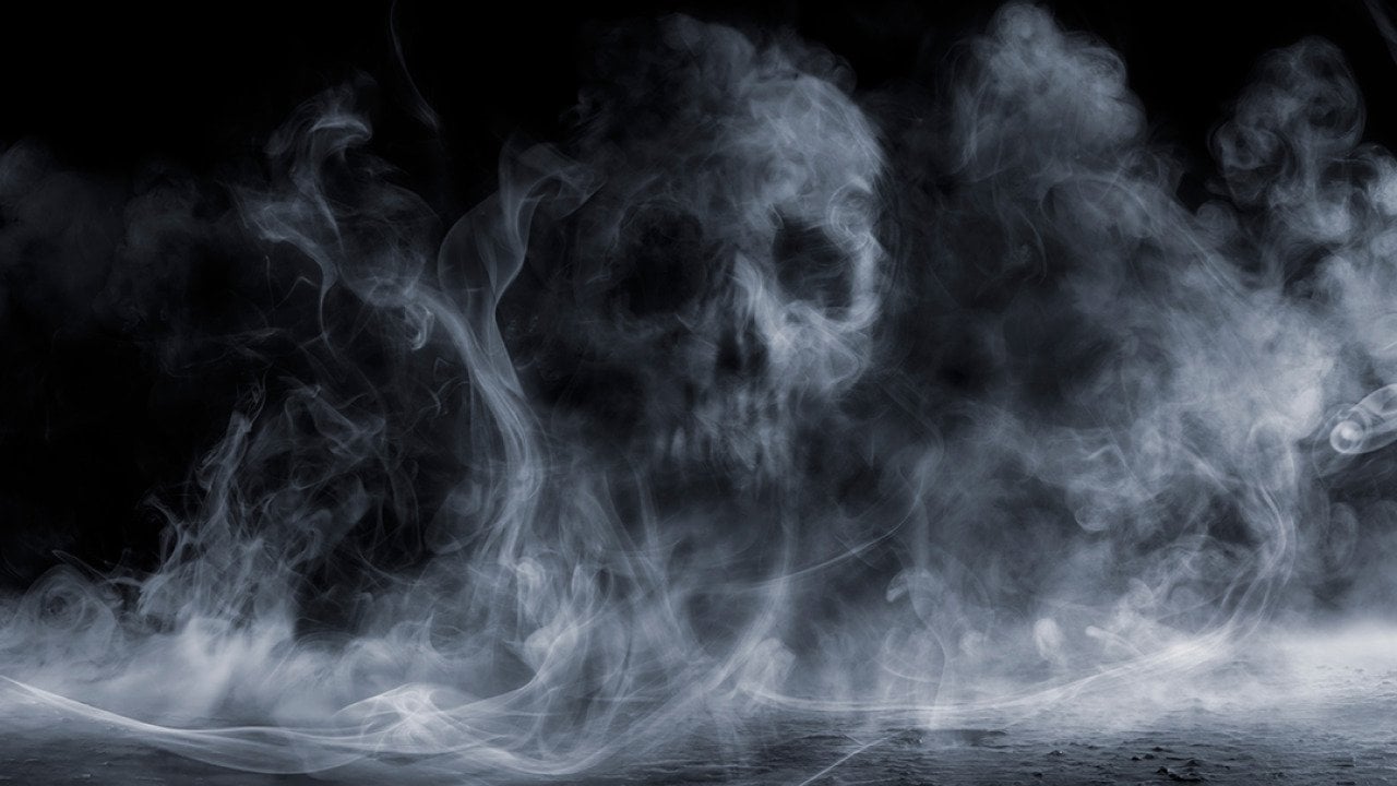 Fog forming a figure of a skull on dark background.