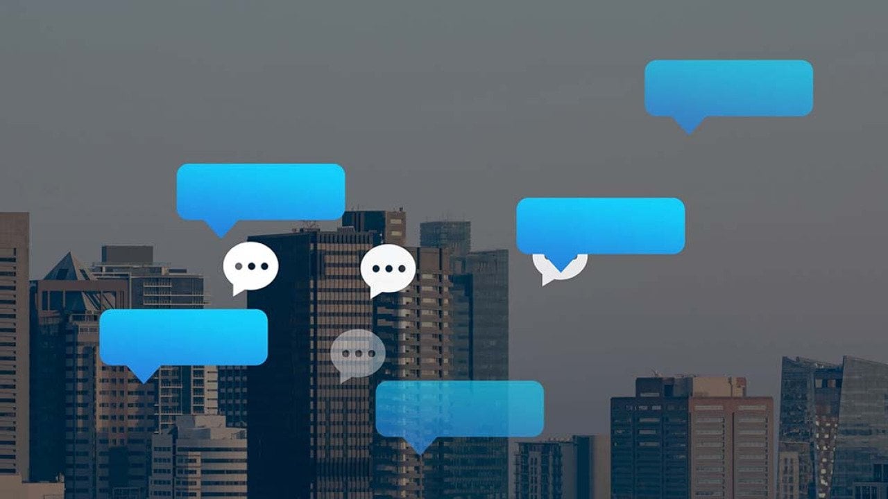 Vector chat and speech bubbles with a backdrop of city buildings.