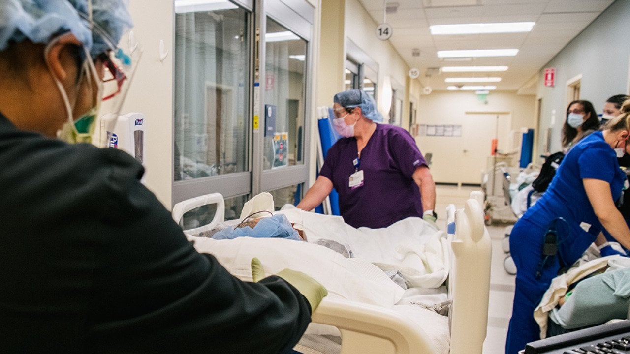 Emergency Room nurses fill a hallway as they tend to patients at the Houston Methodist The Woodlands Hospital in Texas.