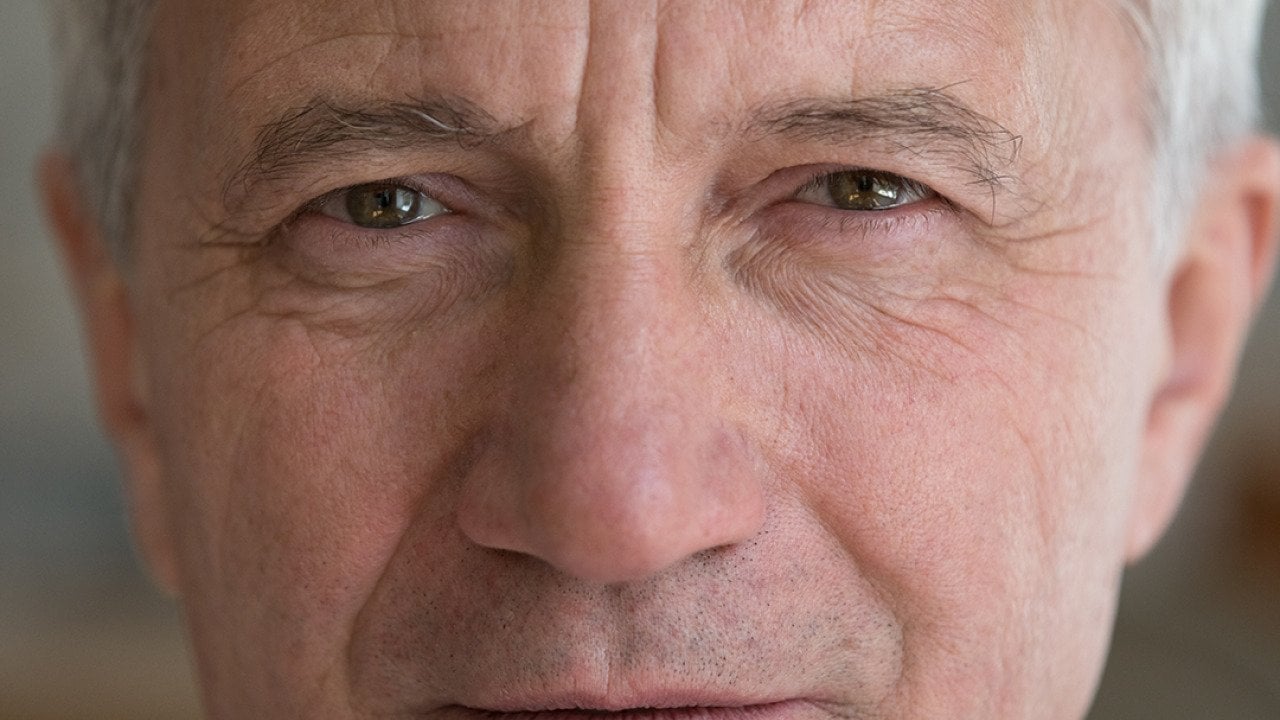 A close up photograph of a white elderly man.
