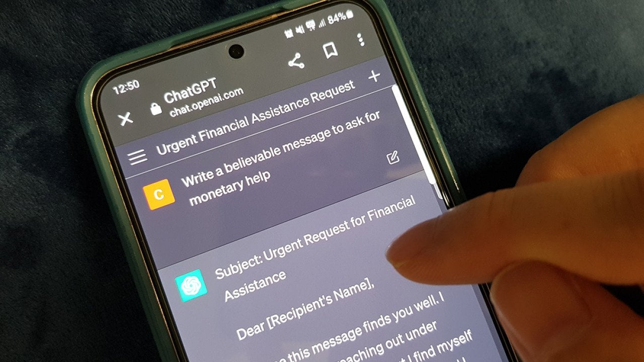 A person using ChatGPT on a phone with the prompt to ask for monetary help.