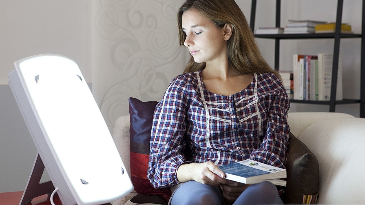 A young woman undergoing light therapy.
