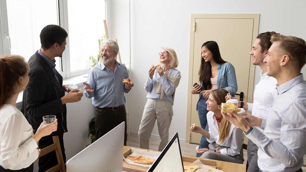 A happy business team having pizza in their office.