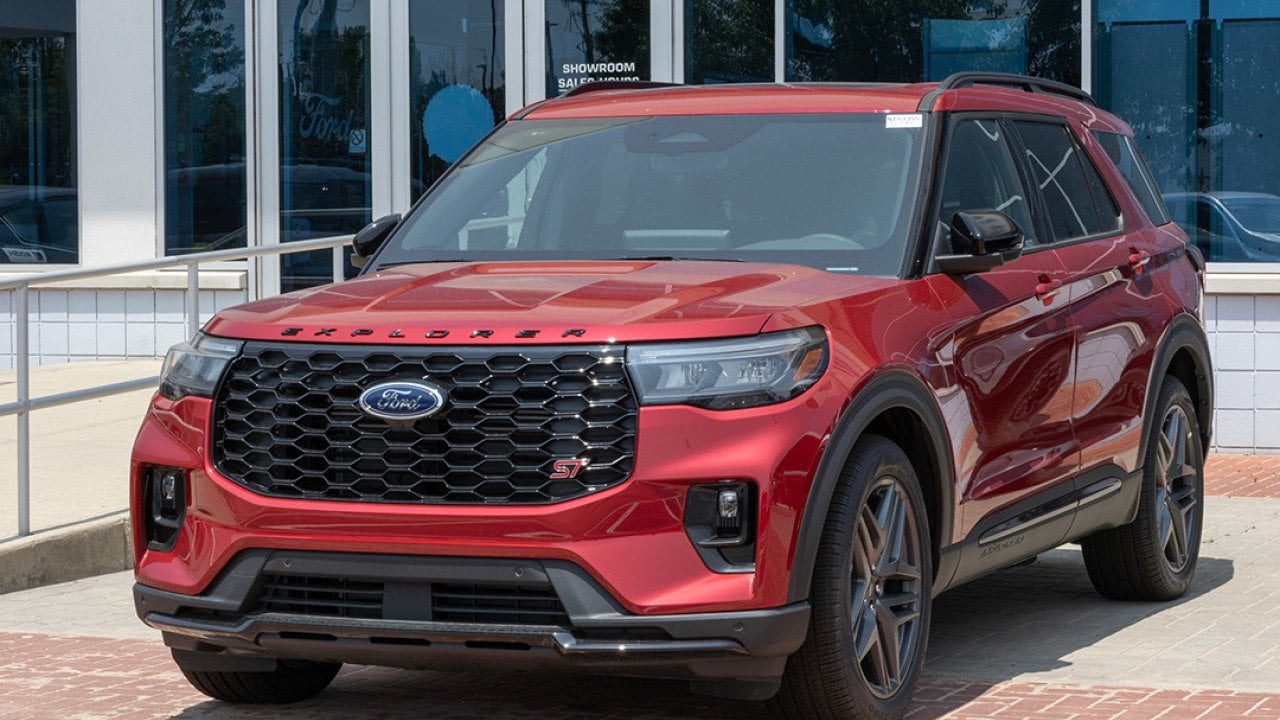 A red 2025 Ford Explorer ST AWD SUV displayed at a dealership.