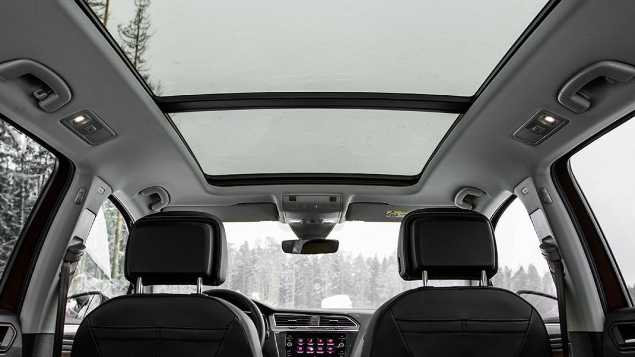A backseat view of a panoramic roof of a car.