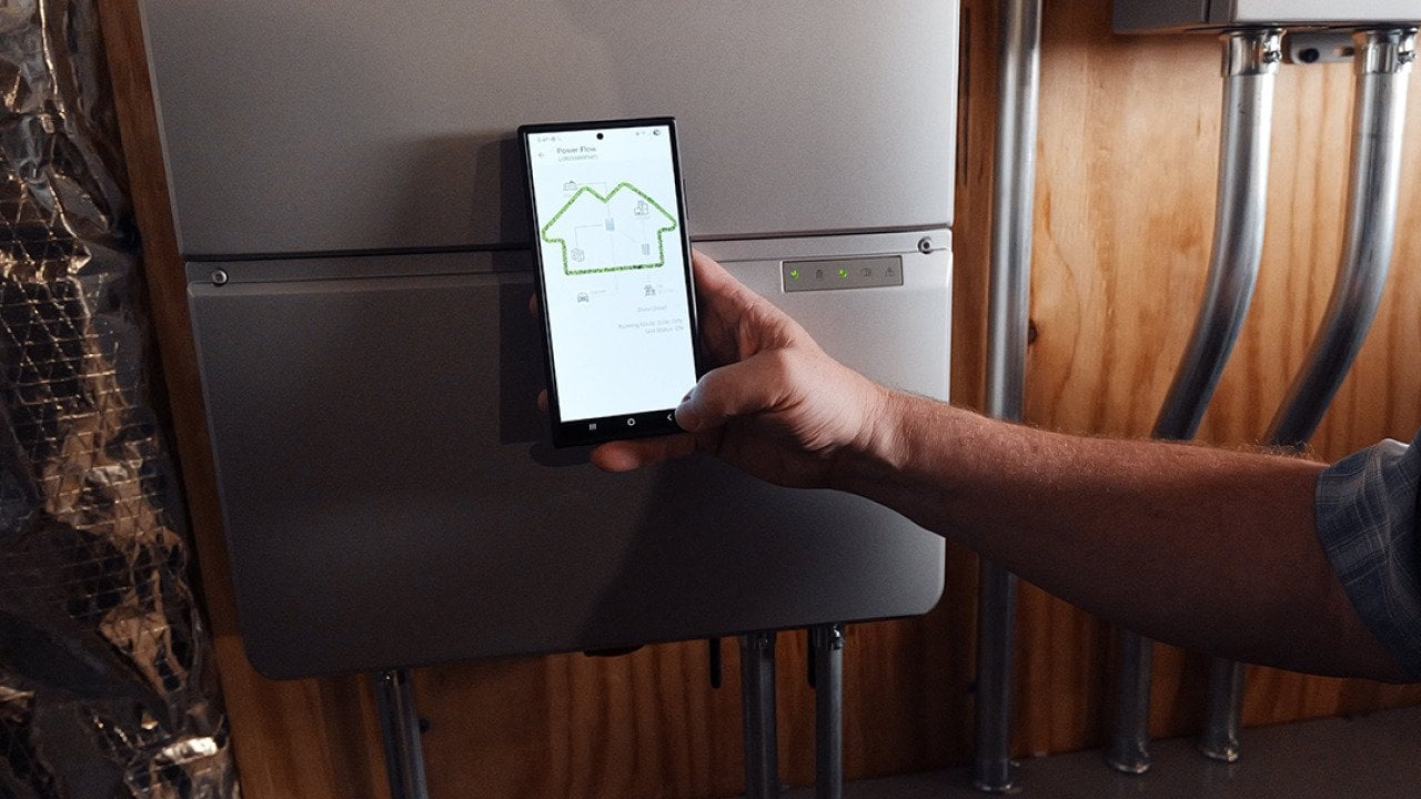 A homeowner using a phone monitoring a battery from Sunrun, a company which provides home solar and batteries. A new partnership between Sunrun, Ford and the Baltimore Gas and Electric Company has resulted in a residential vehicle to grid pilot project.