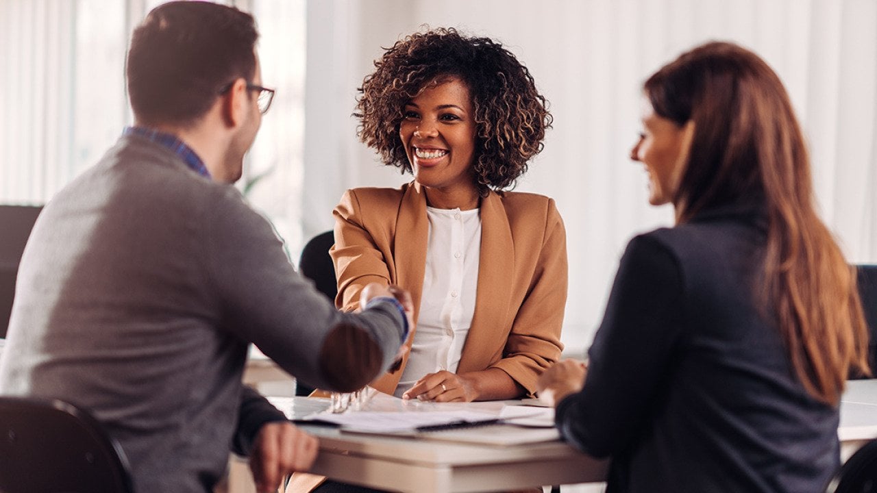 Business people shaking hands in a meeting.