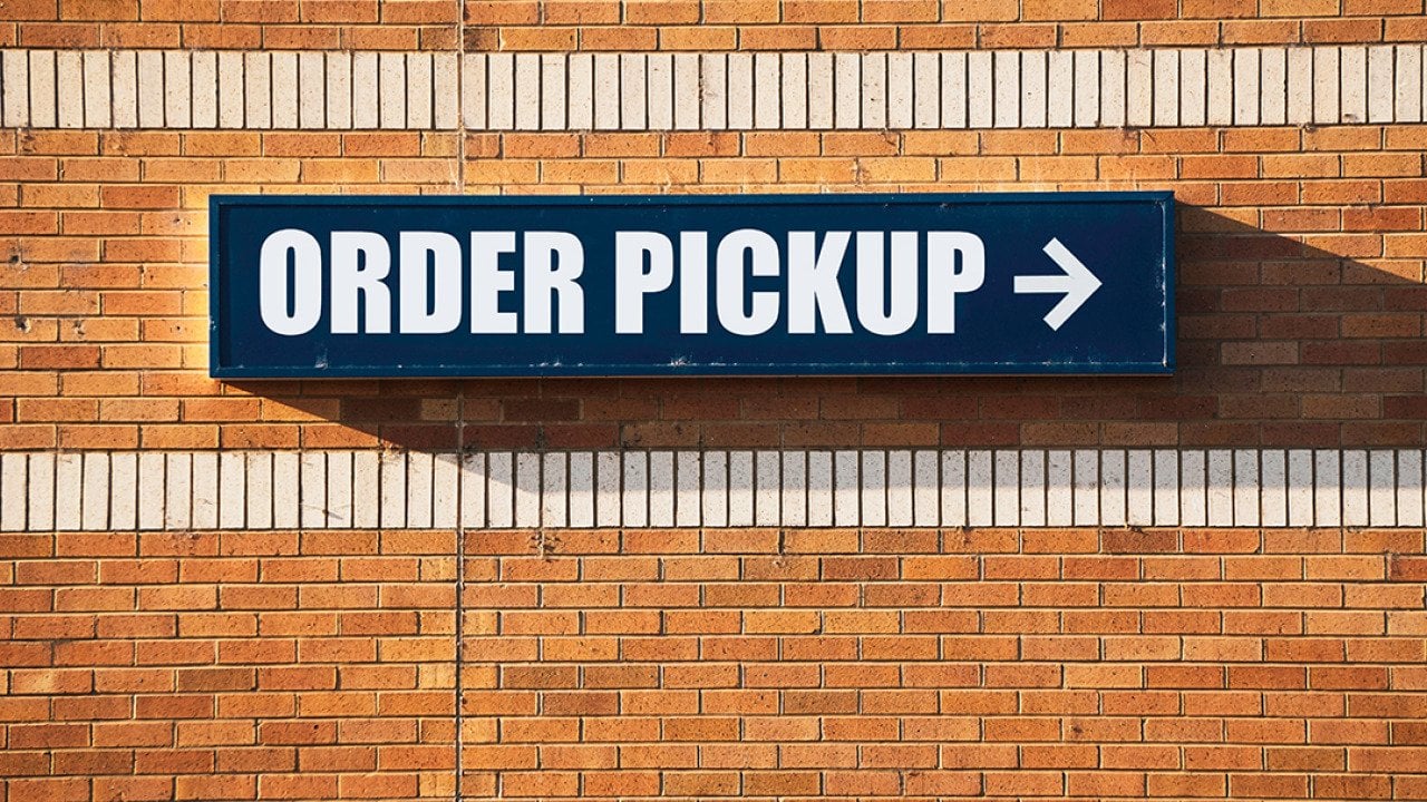 'Order pickup' sign pointing to the left at a store.