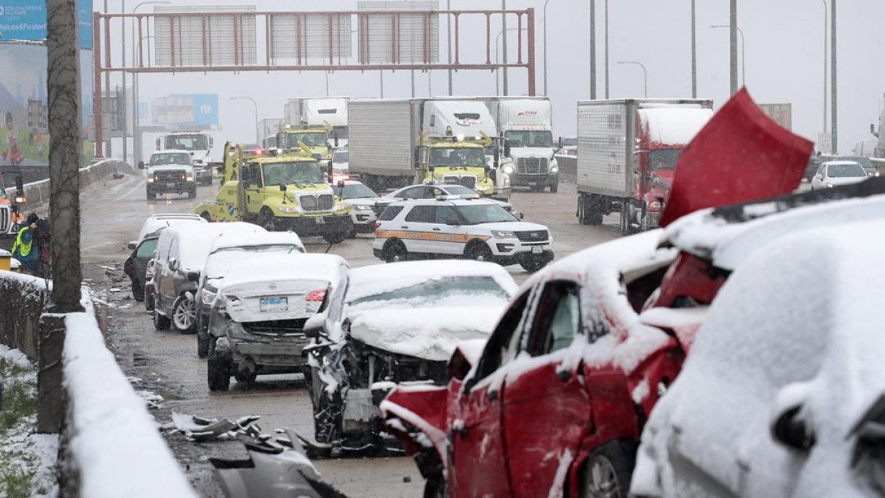 State police supervise the cleanup of a 54-car pileup in the snow on the Kennedy Expressway near downtown on April 15, 2020 in Chicago, Illinois.