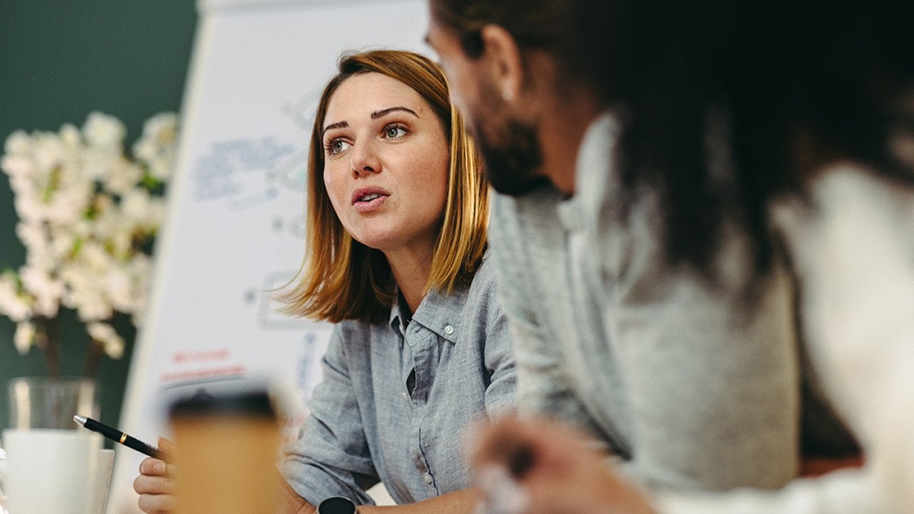 A young businesswoman in a meeting with her colleagues in a boardroom.