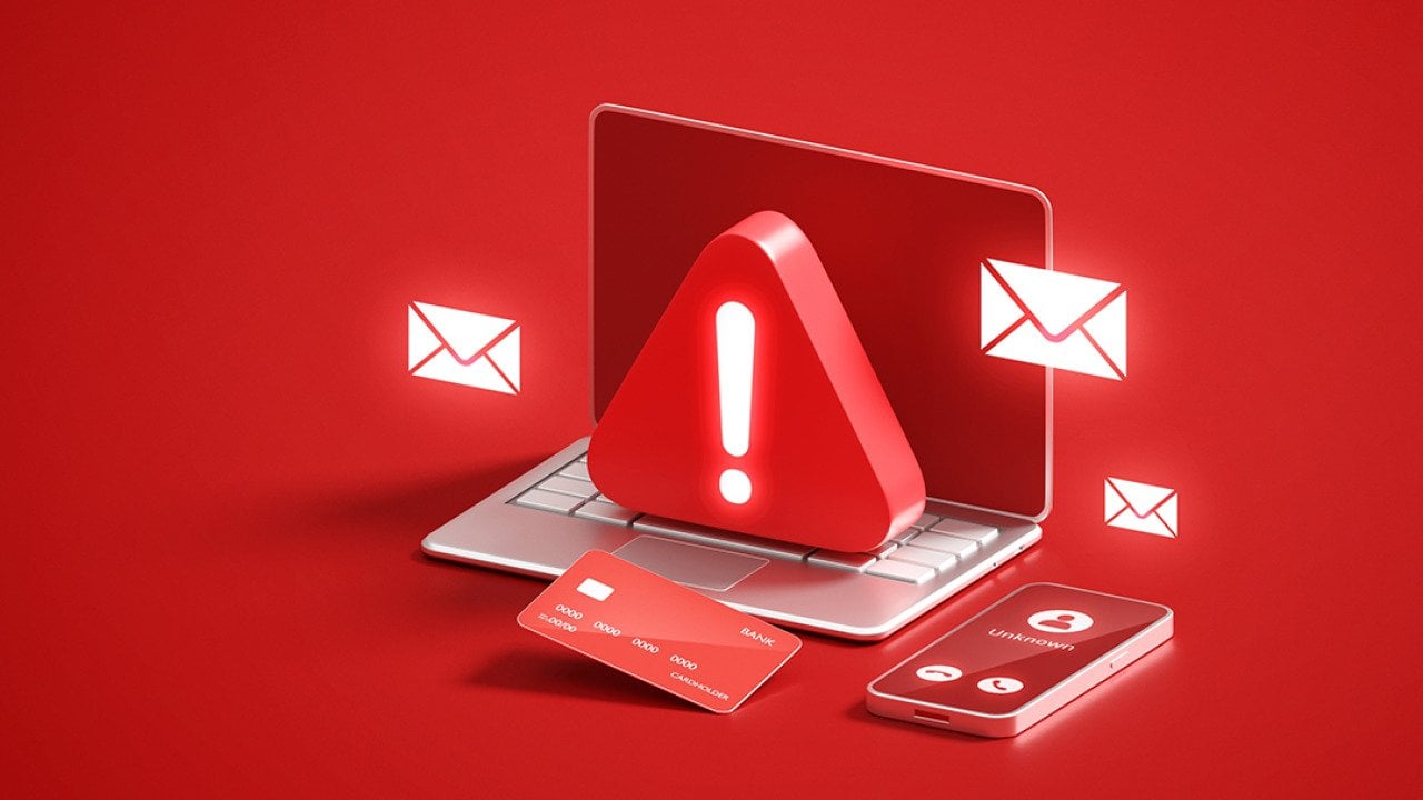 A red 3D illustration of a laptop with a warning sign as a concept of cyber scam or security threat.