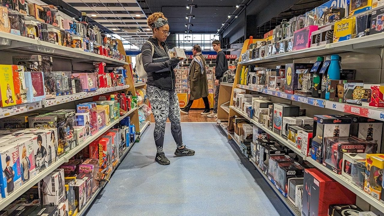  A young adult browsing in a toy and hobby shop aisle.