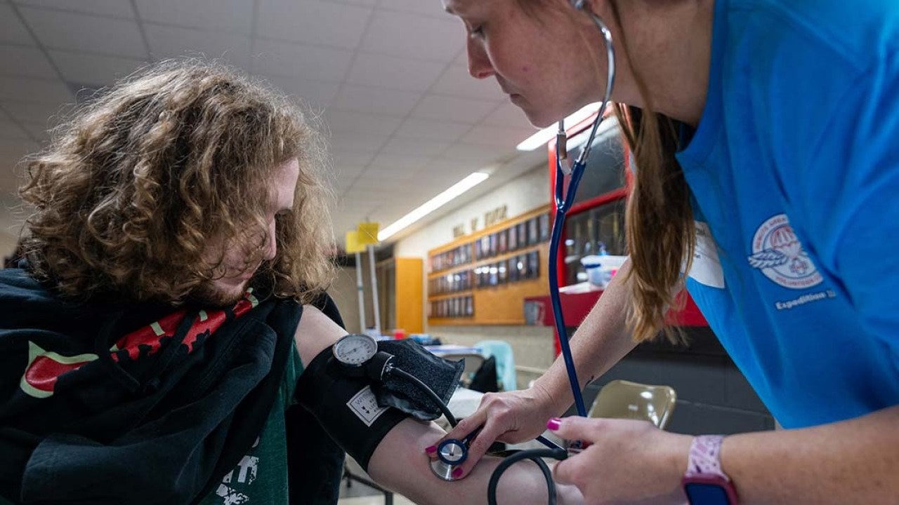 A high school student getting his blood pressure checked at a mobile medical clinic in Terre Haute South High School, Indiana.