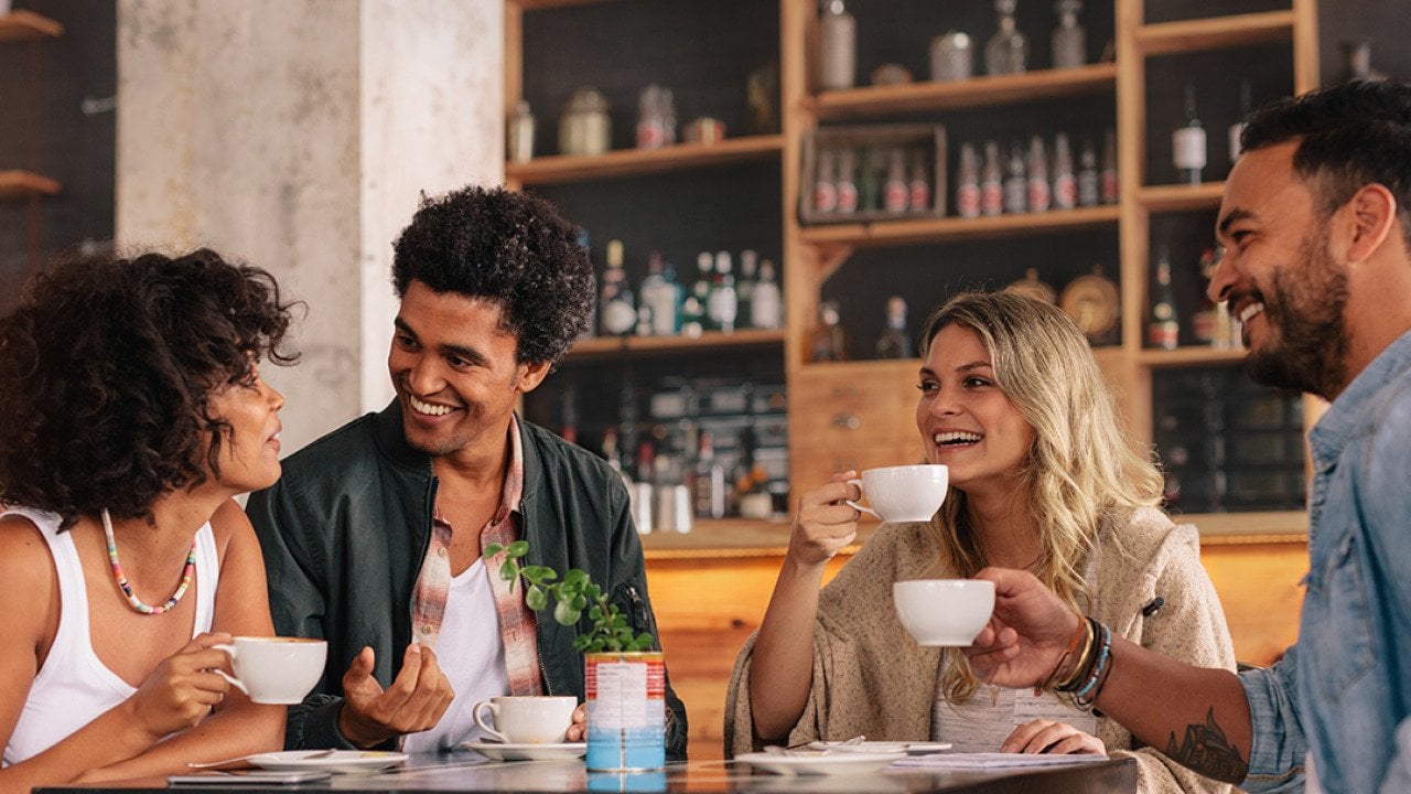 A group of friends having coffee together in a cafe.