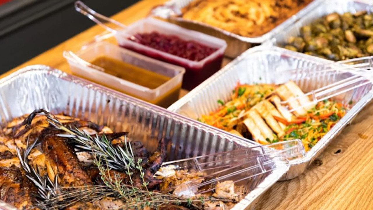 Thanksgiving dishes in catering dishes prepared on the table for serving.