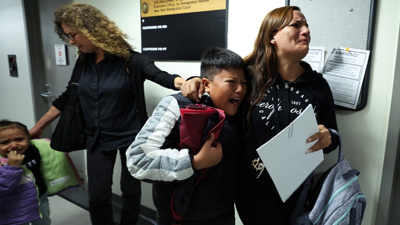 A wife and her children crying as her husband is detained by federal agents outside a New York Federal Plaza Immigration Court room in New York City.