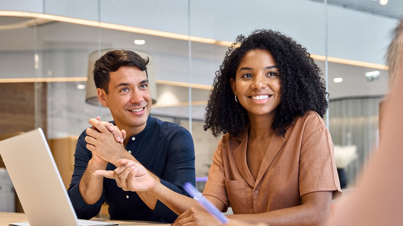 Professional employees discussing a project in their office.