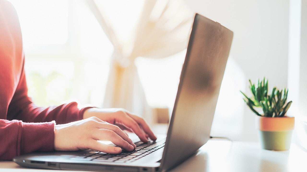 Person typing on a laptop.